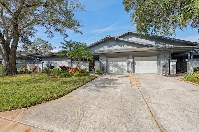 view of front of home featuring a front yard and a garage