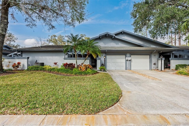 single story home with central AC, a garage, and a front lawn