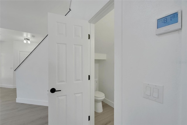 bathroom with wood-type flooring and toilet