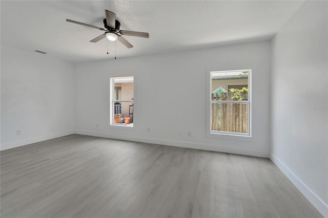 empty room with light wood-type flooring and ceiling fan