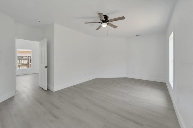 empty room with light wood-type flooring and ceiling fan