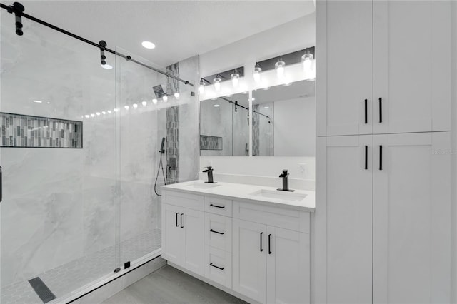 bathroom featuring wood-type flooring, vanity, and an enclosed shower