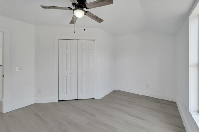 unfurnished bedroom with ceiling fan, light wood-type flooring, and a closet