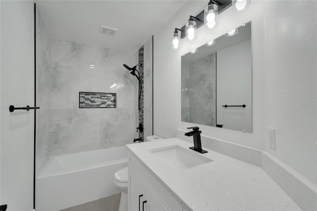 full bathroom featuring vanity, toilet, and tiled shower / bath