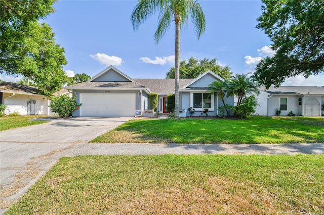 ranch-style home with a garage and a front lawn