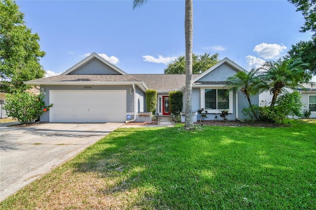 ranch-style home with a garage and a front lawn