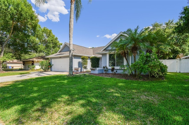 view of front of home with a front yard and a garage