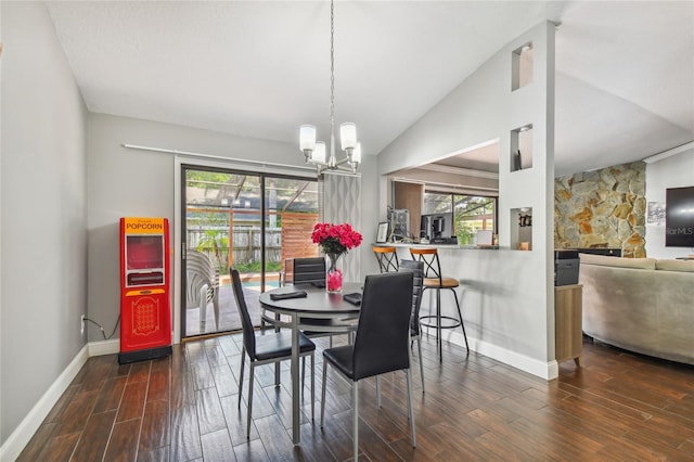 dining space featuring dark hardwood / wood-style floors, plenty of natural light, lofted ceiling, and an inviting chandelier