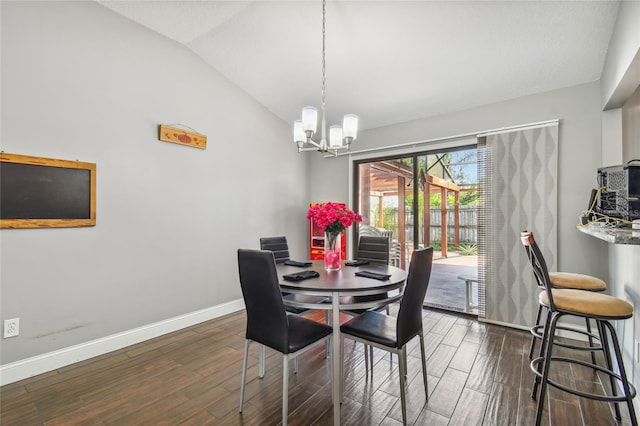 dining area featuring a chandelier, dark hardwood / wood-style flooring, and lofted ceiling