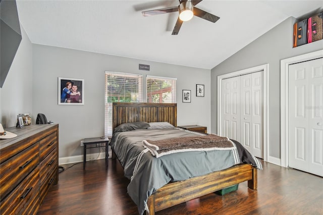 bedroom featuring multiple closets, ceiling fan, dark hardwood / wood-style flooring, and lofted ceiling