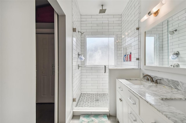 bathroom featuring tile patterned flooring, vanity, and a shower with shower door