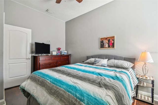 bedroom with dark hardwood / wood-style flooring and ceiling fan