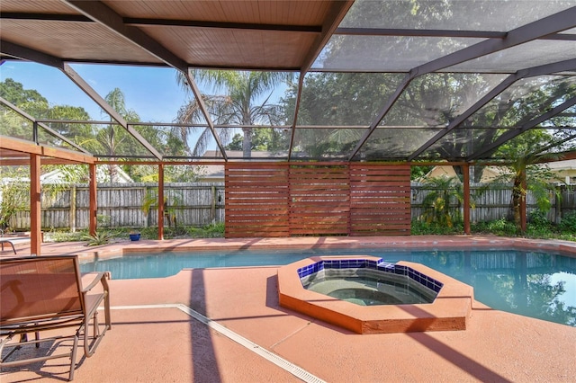 view of swimming pool with an in ground hot tub and glass enclosure