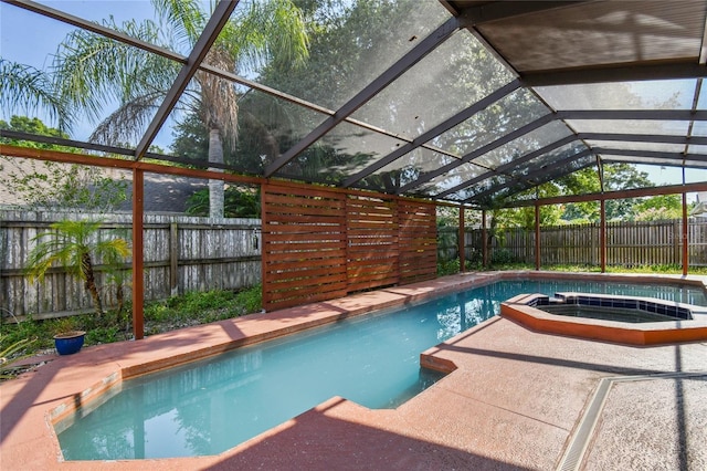 view of swimming pool with a lanai and an in ground hot tub