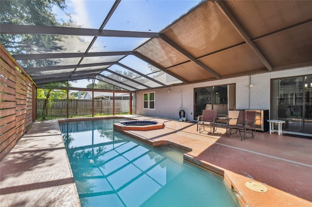 view of swimming pool featuring glass enclosure, an in ground hot tub, and a patio area