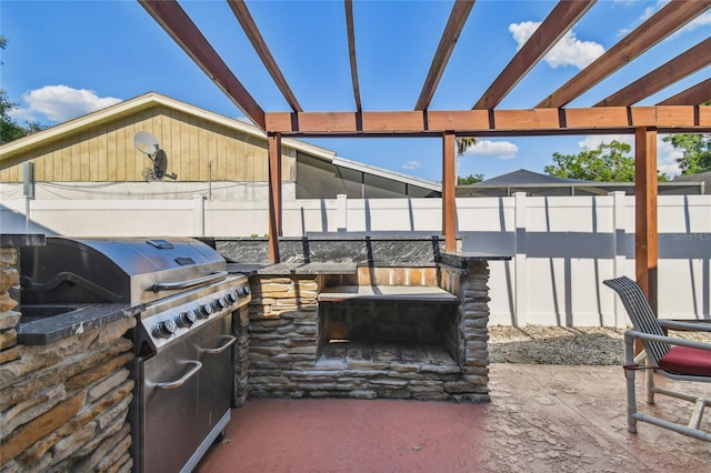 view of patio featuring an outdoor kitchen, a pergola, and grilling area