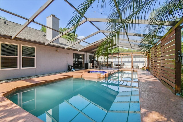 view of pool with a lanai, a patio area, and an in ground hot tub