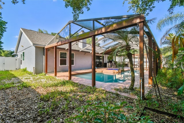 back of property featuring a patio area and a lanai