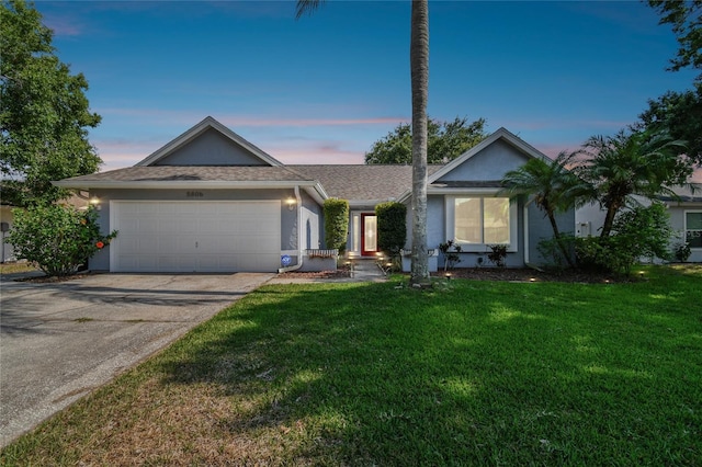 single story home with a yard and a garage