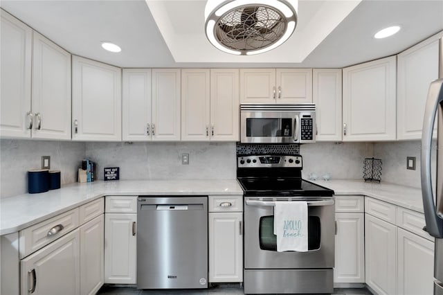 1028 Apollo Beach Blvd Unit 27, Apollo Beach, FL 33572 - kitchen with appliances with stainless steel finishes, white cabinets, tasteful backsplash, and recessed lighting