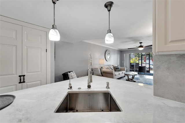 1028 Apollo Beach Blvd Unit 27, Apollo Beach, FL 33572 - kitchen with ceiling fan, hanging light fixtures, light stone counters, ornamental molding, and open floor plan
