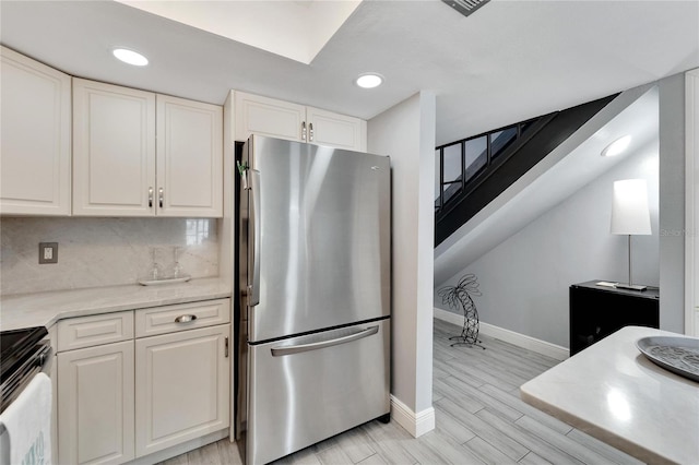 1028 Apollo Beach Blvd Unit 27, Apollo Beach, FL 33572 - kitchen featuring freestanding refrigerator, stove, white cabinetry, recessed lighting, and wood tiled floors