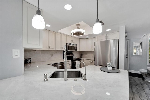 1028 Apollo Beach Blvd Unit 27, Apollo Beach, FL 33572 - kitchen with appliances with stainless steel finishes, light stone countertops, backsplash, decorative light fixtures, and recessed lighting