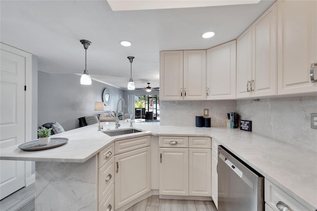 1028 Apollo Beach Blvd Unit 27, Apollo Beach, FL 33572 - kitchen with stainless steel dishwasher, a peninsula, ceiling fan, open floor plan, and backsplash
