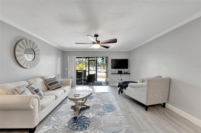 living room featuring ceiling fan, light hardwood / wood-style floors, and ornamental molding