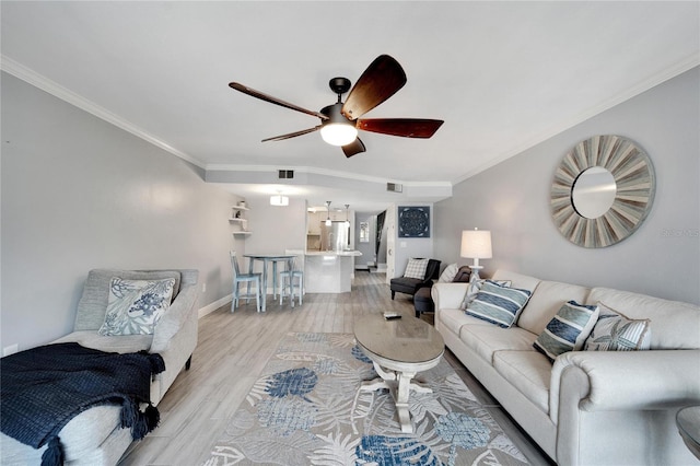 living room featuring ceiling fan, light hardwood / wood-style floors, and crown molding