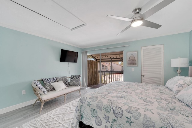 1028 Apollo Beach Blvd Unit 27, Apollo Beach, FL 33572 - bedroom featuring access to exterior, wood finished floors, attic access, ornamental molding, and a ceiling fan