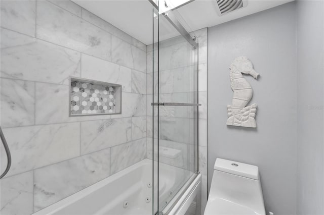 bathroom with combined bath / shower with glass door and toilet