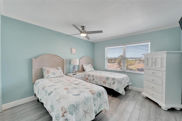 bedroom featuring ceiling fan, ornamental molding, and light hardwood / wood-style flooring