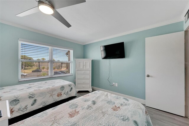 1028 Apollo Beach Blvd Unit 27, Apollo Beach, FL 33572 - bedroom with ornamental molding, wood finished floors, and ceiling fan
