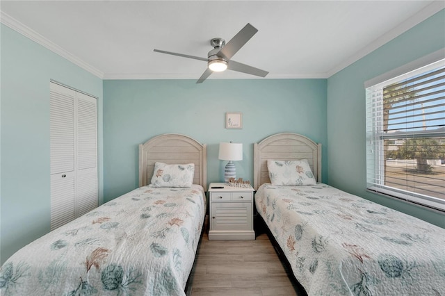 1028 Apollo Beach Blvd Unit 27, Apollo Beach, FL 33572 - bedroom featuring ornamental molding, wood finished floors, a closet, and ceiling fan