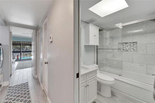 full bathroom with vanity, toilet, and enclosed tub / shower combo