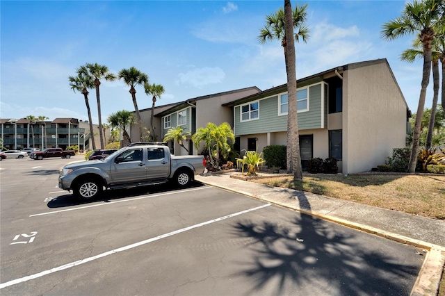 1028 Apollo Beach Blvd Unit 27, Apollo Beach, FL 33572 - view of front of property with stucco siding, uncovered parking, and a residential view