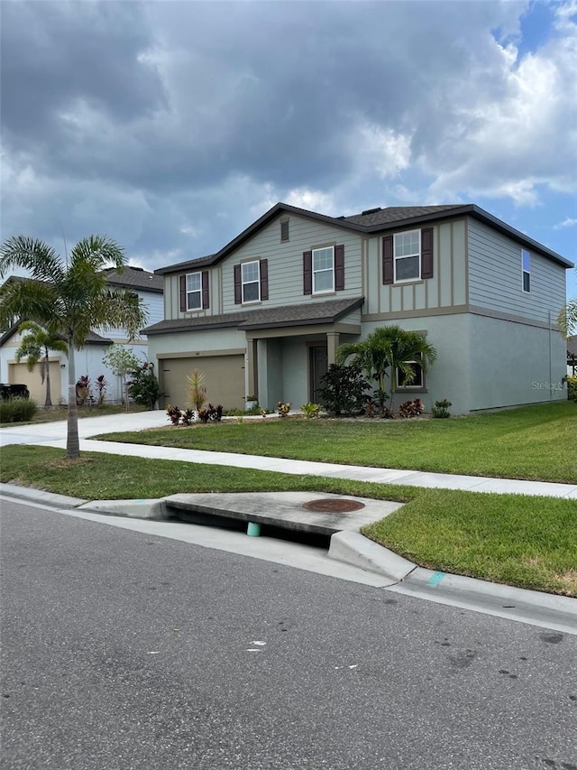 view of front of property featuring a front yard and a garage