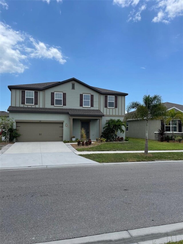 view of front of house with a garage and a front lawn