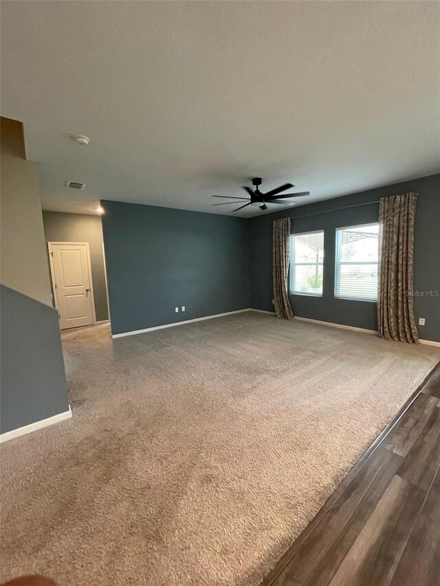 spare room with hardwood / wood-style floors and ceiling fan