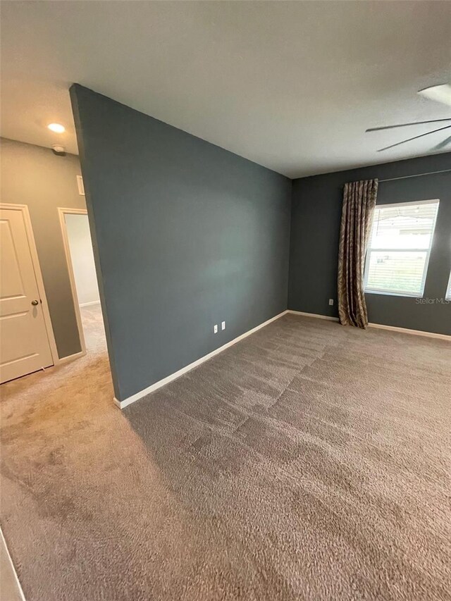 spare room featuring light colored carpet