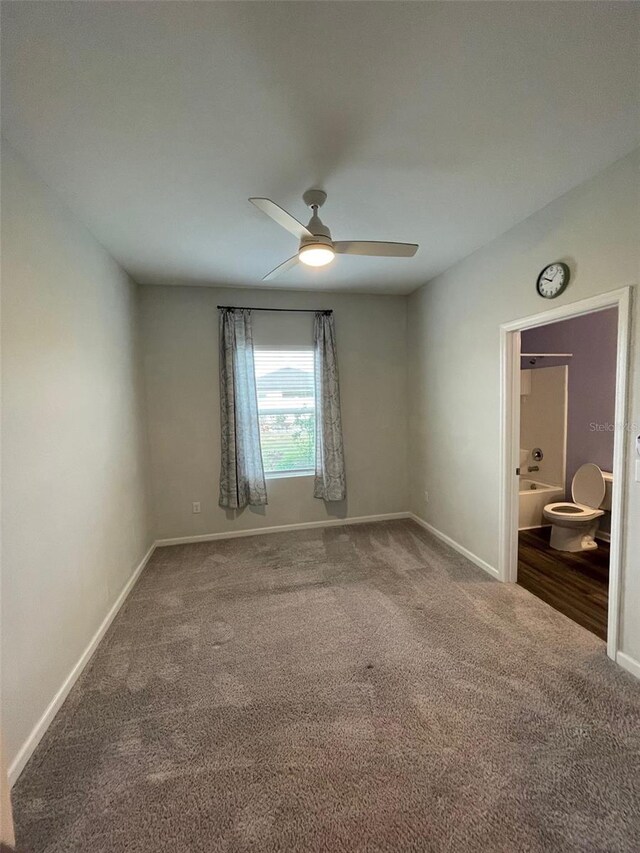 empty room featuring ceiling fan and carpet floors