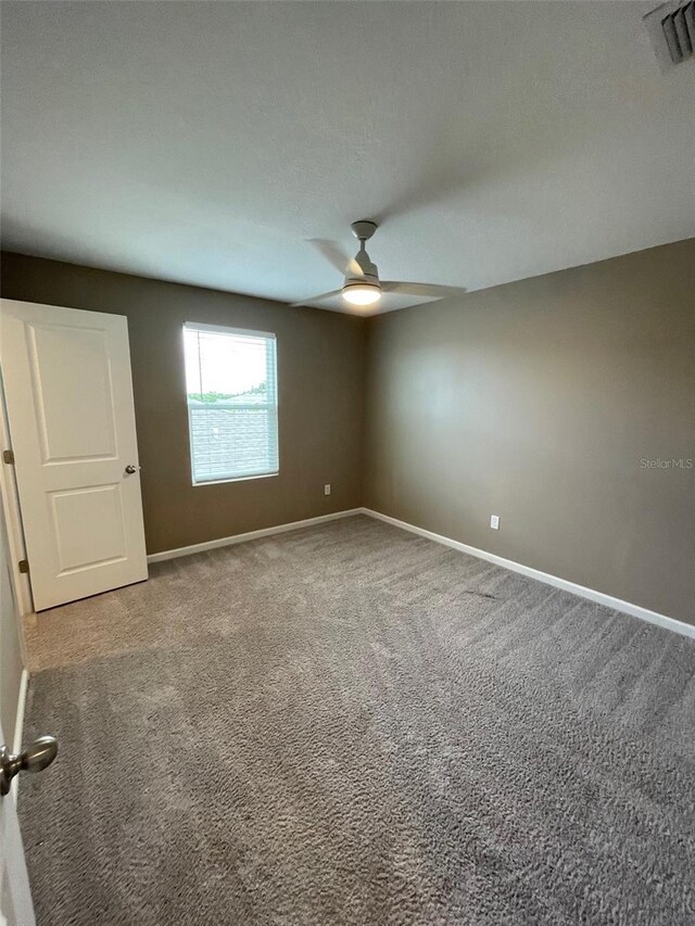 empty room with carpet flooring and ceiling fan