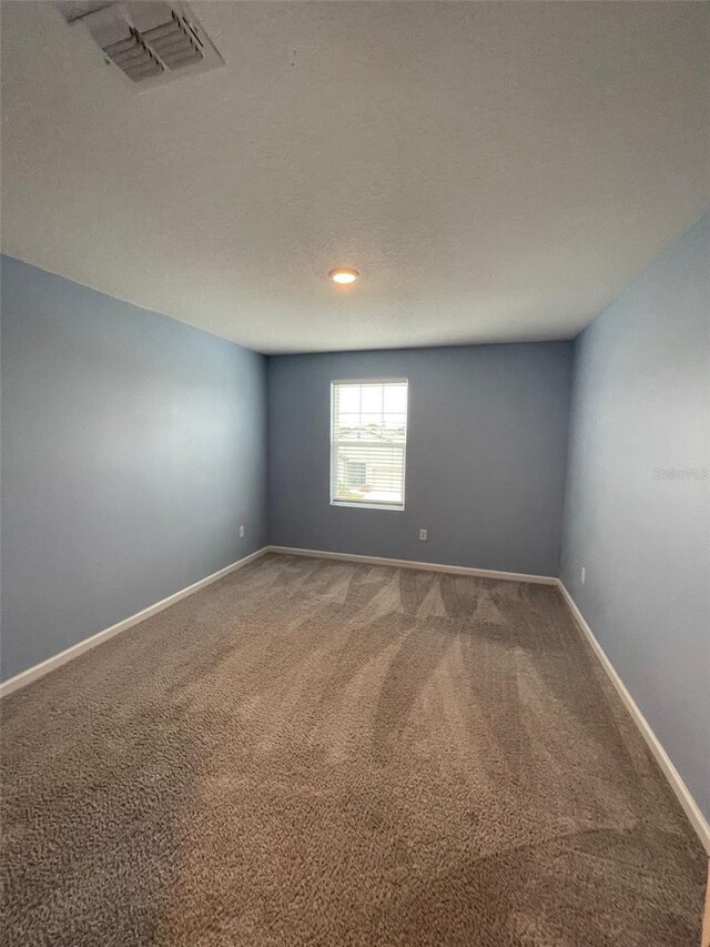 unfurnished room featuring carpet