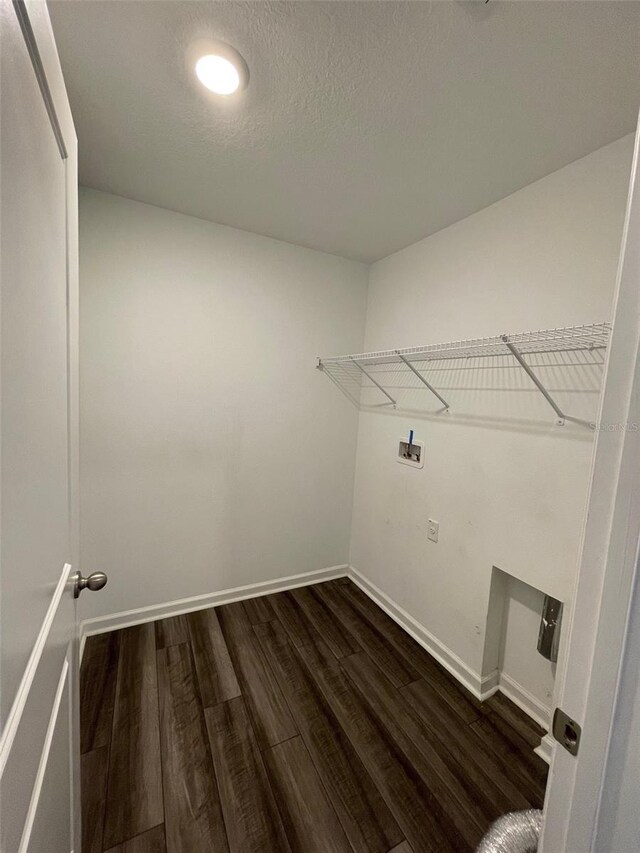 washroom featuring dark hardwood / wood-style flooring, a textured ceiling, and hookup for a washing machine