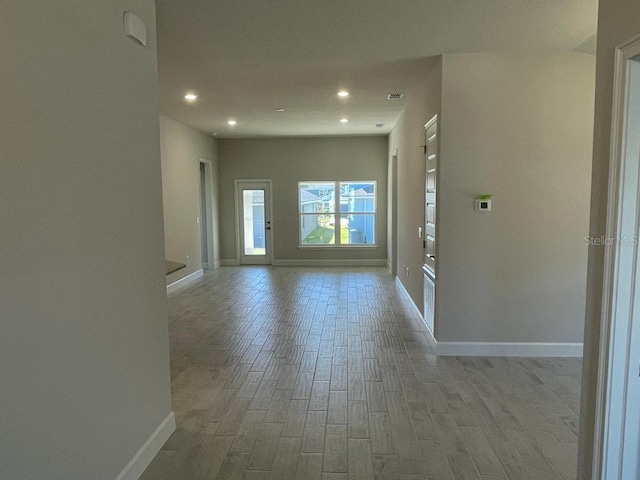 empty room with light hardwood / wood-style flooring