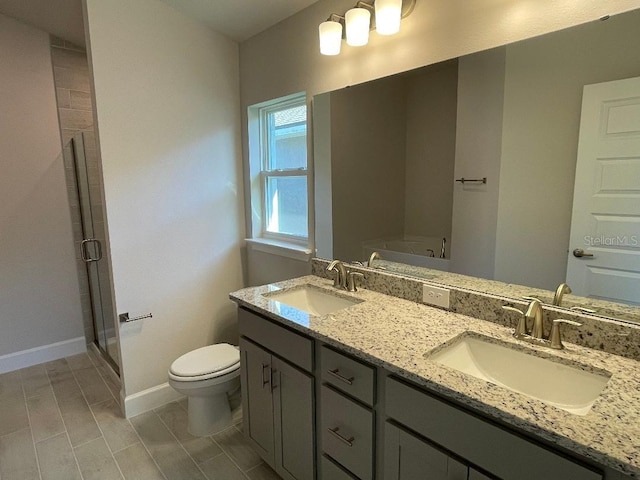 bathroom with vanity, an enclosed shower, and toilet