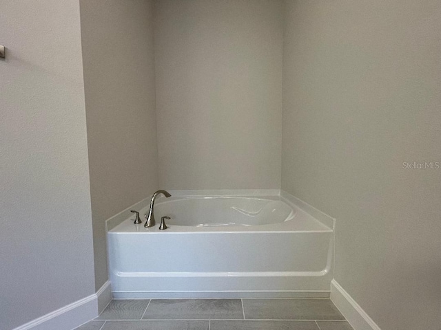 bathroom with tile patterned flooring and a bathtub