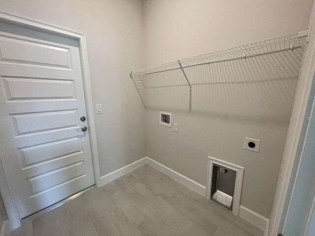 laundry area with hardwood / wood-style flooring, washer hookup, and hookup for an electric dryer