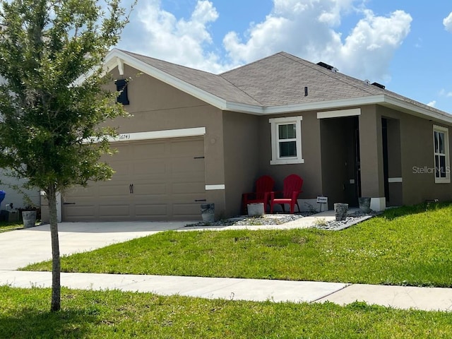 single story home featuring a garage and a front yard